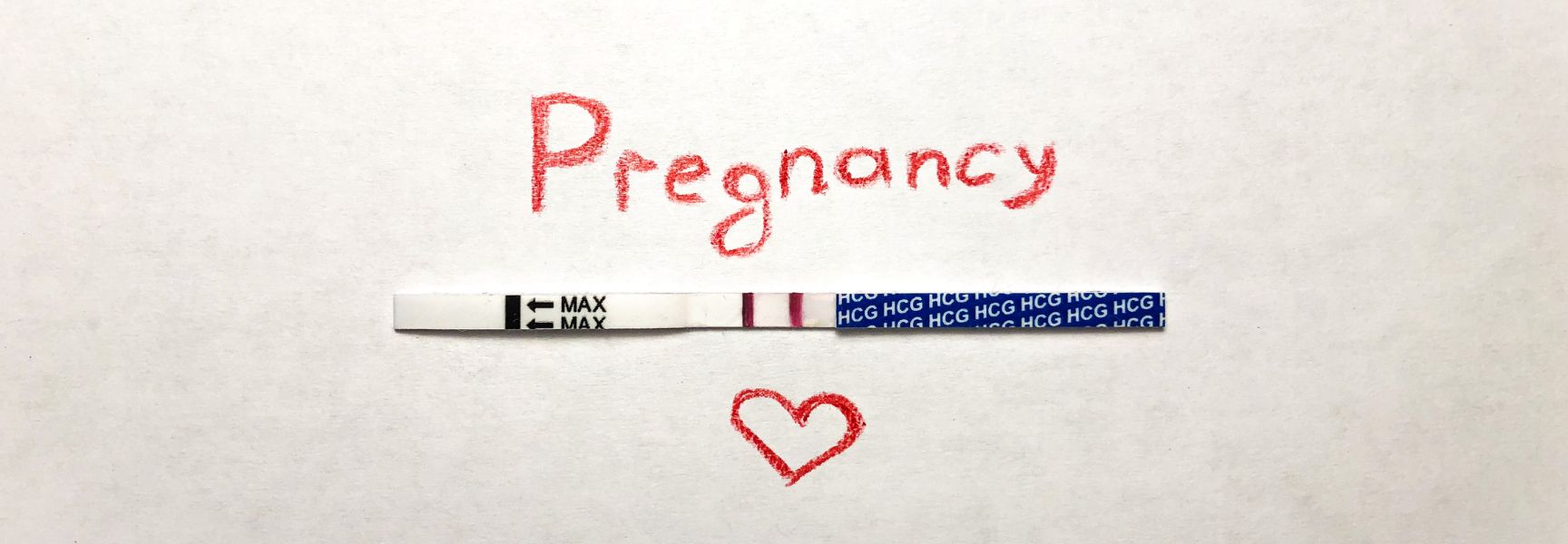 The word Pregnancy with an image of a pregnancy test strip